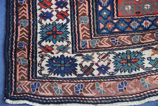 A Caucasian red ground rug, 6ft 10in by 5ft 3in